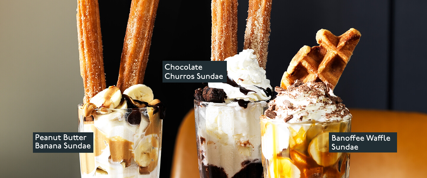 A selection of Beefeater sundaes in glasses including peanut butter, chocolate churros and banoffee waffles.